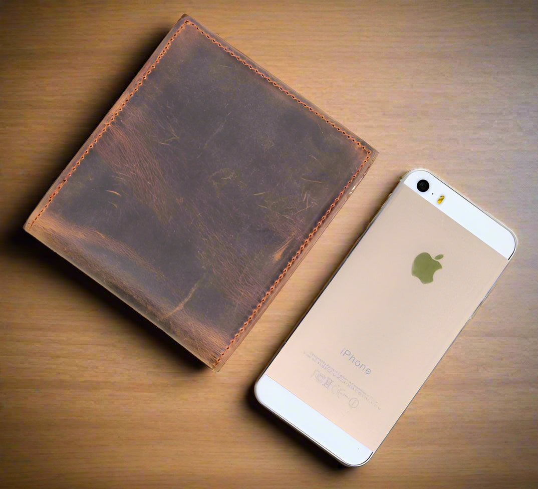 Stylish Crazy Horse Leather Wallet beside a smartphone, showcasing elegant cowhide craftsmanship and timeless design.