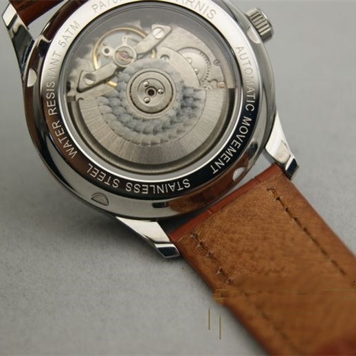 Parnis Automatic watch with transparent case back, visible movement, stainless steel case, brown leather strap.