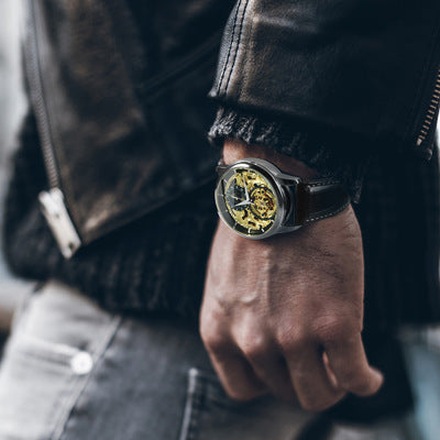 Stylish Carved Hollow Automatic Mechanical Watch with gold shell, transparent back, and leather strap for a timeless look.